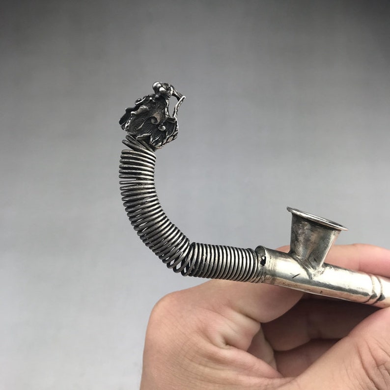 A tobacco pouch carved by hand from a silver statue of ancient Tibet in China
