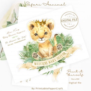 May include: A printable baby shower topper featuring a cute cartoon lion cub wearing a gold crown and surrounded by green leaves. The topper says "Welcome Baby Oliver".