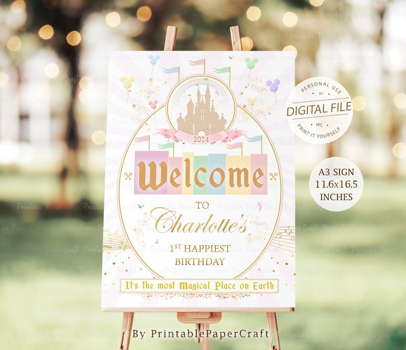 May include: A printable sign for a 1st birthday party with a pink, blue, and yellow color scheme. The sign features a castle, a rainbow, and the text "Welcome to Charlotte's 1st Happiest Birthday. It's the most magical place on Earth." The sign is 11.6 inches by 16.5 inches.