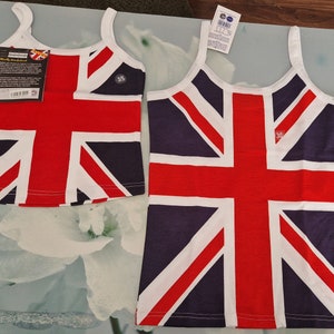 May include: Two Union Jack flag design vest tops in red, white, and navy blue. One is size 3/5, the other is size 30. Both have white straps and trim. Tags are attached. A classic British design.