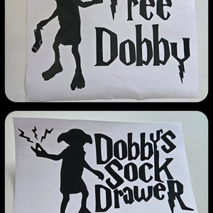 May include: Two black vinyl decals on white paper. One shows a silhouette of a creature with the text "Free Dobby" and stars. The other features the same creature with the text "Dobby's Sock Drawer".