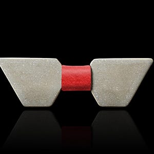 May include: A silver bow tie with a red bow in the centre.
