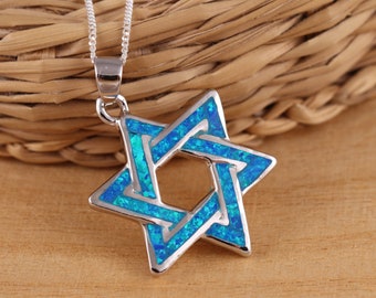 May include: A silver chain necklace with a blue opal Star of David pendant.