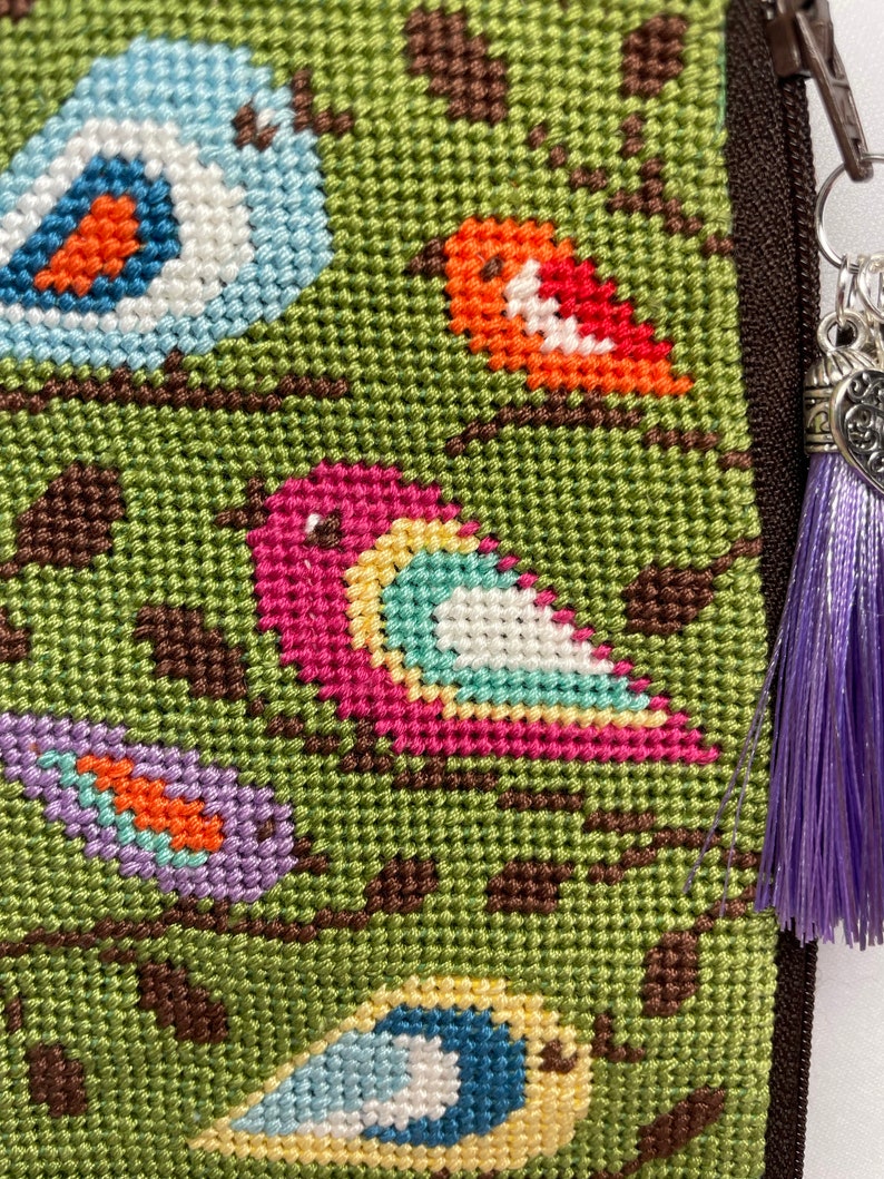 A Finished Needlepoint Eyeglass Case With Birds on Branches. It Has a
