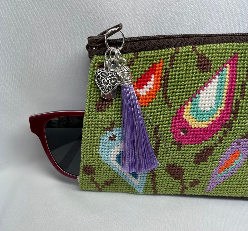 A Finished Needlepoint Eyeglass Case With Birds on Branches. It Has a