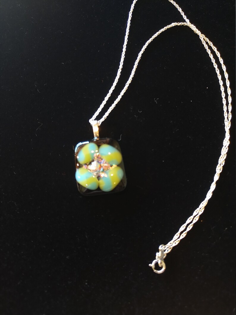 Tourquoise and Spring Green Spiral on black glass with rainbow dichroic glass center on sterling silver necklace by Deborah Tom