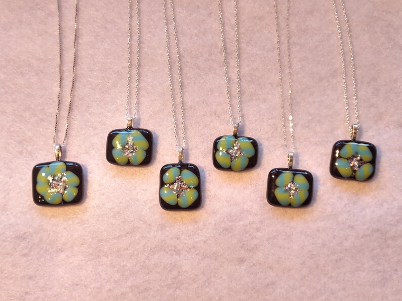 Tourquoise and Spring Green Spiral on black glass with rainbow dichroic glass center on sterling silver necklace by Deborah Tom