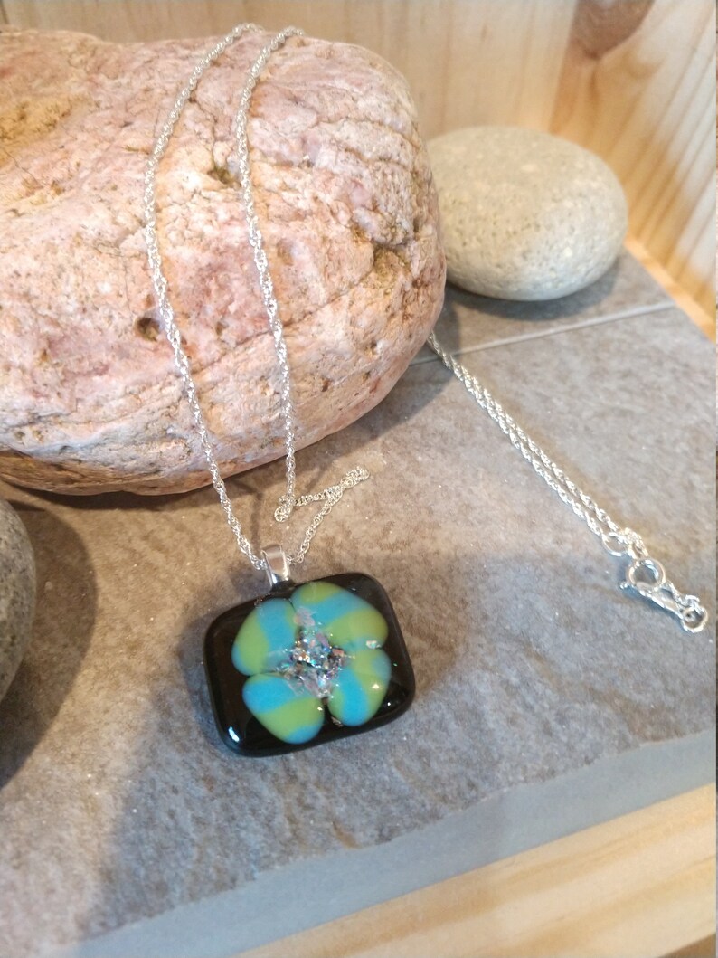 Tourquoise and Spring Green Spiral on black glass with rainbow dichroic glass center on sterling silver necklace by Deborah Tom
