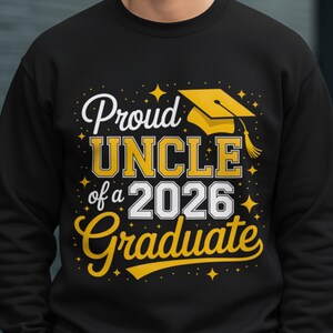 May include: Black sweatshirt with the text "Proud UNCLE of a 2026 Graduate" in white and yellow. A yellow graduation cap graphic is above the text. The design includes star accents.