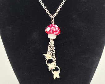 Red mushroom and snake vertebrae dangle necklace