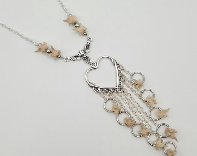 Heart and rattlesnake vertebrae dangle necklace