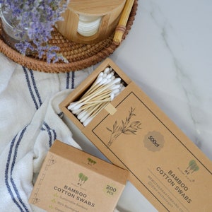 May include: Two boxes of bamboo cotton swabs. The smaller box is brown with white text and says "Bamboo Cotton Swabs" and "200 pcs". The larger box is brown with white text and says "Bamboo Cotton Swabs" and "500ct".