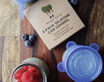 May include: A set of six blue silicone can covers with the text "6-Pack Silicone Can Covers" on a brown box. The box also has the text "ME Mother Earth" and "Reusable & BPA Free, Durable & Stretchy, Top Rack Dishwasher Safe".
