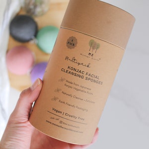 May include: A brown cardboard tube with a white label that says "ME Mother Earth" and "Multipack Konjac Facial Cleansing Sponges". The label also says "Made from Japanese Konjac Vegetable Roots", "Naturally Cleanse + Exfoliate", "Earth Friendly Packaging", "Vegan | Cruelty Free", and "Join us! @me_motherearth www.memotherearthbrand.com".
