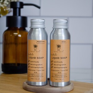 May include: Two silver bottles of Castile liquid soap, one labeled "Peppermint" and the other "Citrus". Both bottles are 3 oz and are labeled "Earth Friendly", "Natural Ingredients", "Guilt-Free Packaging", "Multipurpose | Travel Size", and "Made in the USA".