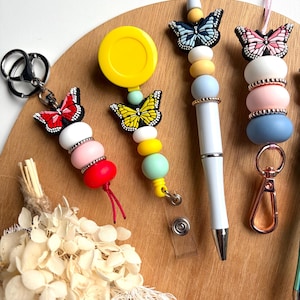 The Flutter Collection. Handmade beaded butterfly accessories - keychains, lanyards, pens, badge reels and car diffusers