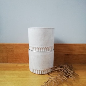 White carved ceramic tumbler beaker