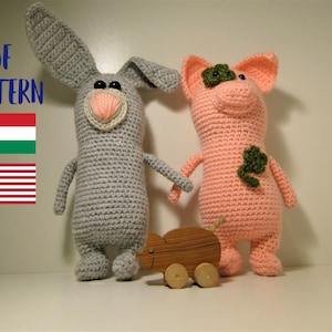 May include: Crochet pattern PDF for a grey bunny and a pink pig. The PDF pattern is available in both English and Hungarian. The bunny and pig are standing next to each other, and there is a small wooden toy mouse in front of them.