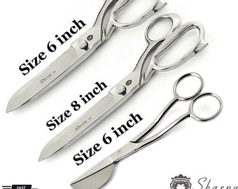 May include: Three pairs of silver scissors with black handles. The scissors are labeled with their sizes: 6 inch, 8 inch, and 6 inch. The brand name "Sharpy England" is visible in the bottom right corner.