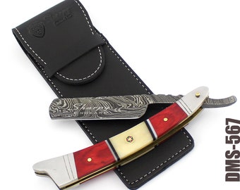 May include: A straight razor with a red and white handle and a Damascus steel blade. The razor is in a black leather case. The case has the text "Sharpy England" on it. The razor has the text "Sharpy England" on the blade.