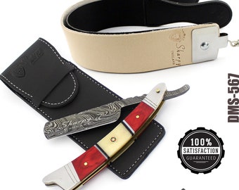 May include: A straight razor with a red and white handle and a Damascus steel blade. The razor is in a black leather case and comes with a leather strop. The strop is beige with black leather trim and has the text "Sharpy England" on it. The razor is labeled "DMS-5697".