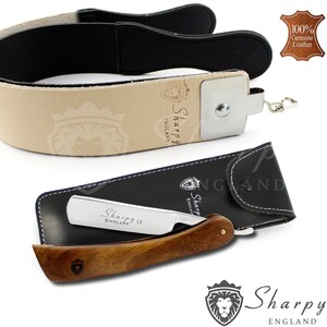 May include: A straight razor with a wooden handle and a leather strop. The razor has a silver blade with the text "Sharpy England CE" on it. The strop is made of brown leather with a black leather strap. The strop has the text "Sharpy England" on it.