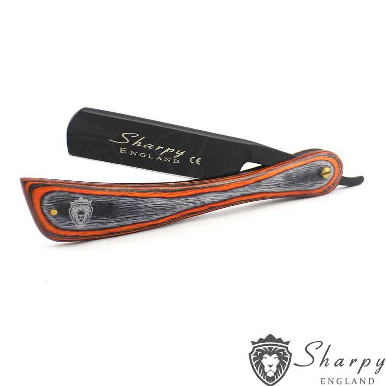 May include: A black straight razor with a wooden handle. The handle is made of wood with orange and gray stripes. The razor has the words "Sharpy England CE" on the blade.