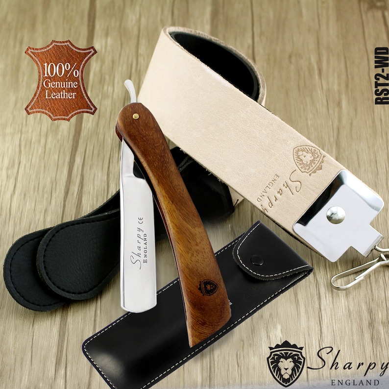 May include: A wooden handled straight razor with a silver blade. The razor is engraved with the words "Sharpy England CE". The razor is in a black leather case with a brown leather strap and a silver metal buckle. The strap is labelled "Sharpy England".