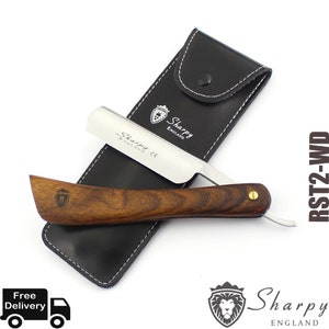 May include: A silver straight razor with a wooden handle and a black leather case. The razor has the text "Sharpy England CE" engraved on the blade. The case has the text "Sharpy England" on it.