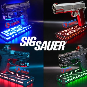 May include: Four images showcasing different firearms, each mounted on a glowing LED display base. The bases emit blue, red, and green light. The text "SIG SAUER" is prominently displayed. The "HALO MACHINE" logo is visible on each base.