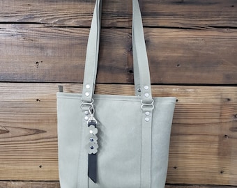 Beautiful soft leather bag/tote.  Beautiful light sage 100 percent cow hide leather. Zipper top, inside pockets.  Made in the USA.