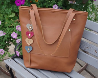 Beautiful large leather tote/bag.   Full grain cow hide leather. Zip top. Leather heart keychain. Cotton lined w/pocket.  USA made.
