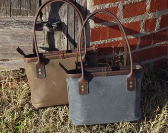 Perfect waxed canvas and leather shoulder bag. With zipper closure, cotton lined with pockets, leather handles and bottom. Made in the USA