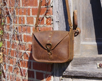 Perfect leather crossbody bag. Beautiful rustic brown leather bag with all solid brass hardware. Inside zip pocket. Made in the USA.