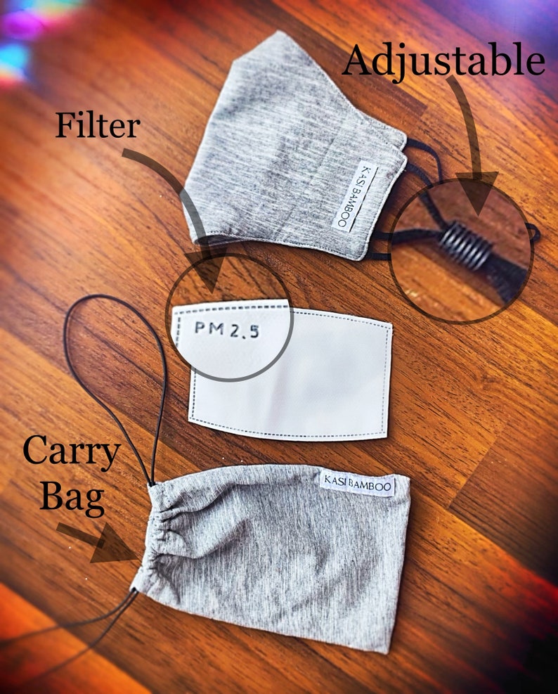 May include: A gray face mask with adjustable straps and a filter pocket. The mask is made of a soft, breathable fabric and comes with a carrying bag. The filter is labeled "PM 2.5".
