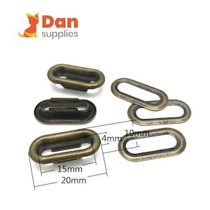 Op de afbeelding: Antiek messing ovale ogen. De ogen zijn 20 mm lang, 15 mm breed en 4 mm dik. De opening is 10 mm lang. De afbeelding bevat de tekst "Dan supplies".