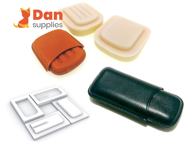 May include: Four different types of cigar cases. Two are made of leather, one is brown and one is black. The other two are made of a white material and are empty.