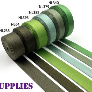 May include: Assortment of green, olive, and gray webbing straps with different widths. The straps are rolled up and labeled with the product codes NL340, NL379, NL382, NL393, NL64, and NL233. DAN SUPPLIES is printed in purple below the straps.