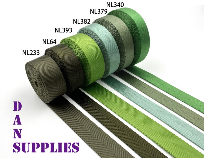May include: Assortment of green, olive, and gray webbing straps with different widths. The straps are rolled up and labeled with the product codes NL340, NL379, NL382, NL393, NL64, and NL233. DAN SUPPLIES is printed in purple below the straps.