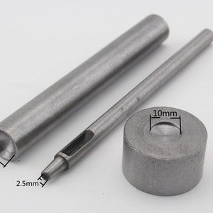 May include: A set of three metal tools for leather crafting. The tools include a 10mm punch, a 10mm hollow punch, and a 2.5mm punch.