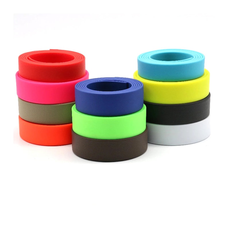 May include: A stack of colorful, round, plastic webbing straps. The straps are in various colors, including red, pink, green, blue, yellow, orange, brown, and white.