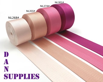 May include: Five rolls of pink, peach, and white webbing with the product codes NL268#, NL355#, NL274#, NL301#, and DAN SUPPLIES printed on the image.