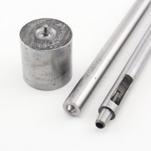 May include: A set of three metal tools for leather crafting. The tools include a round punch, a hollow punch, and a punch with a pointed tip.
