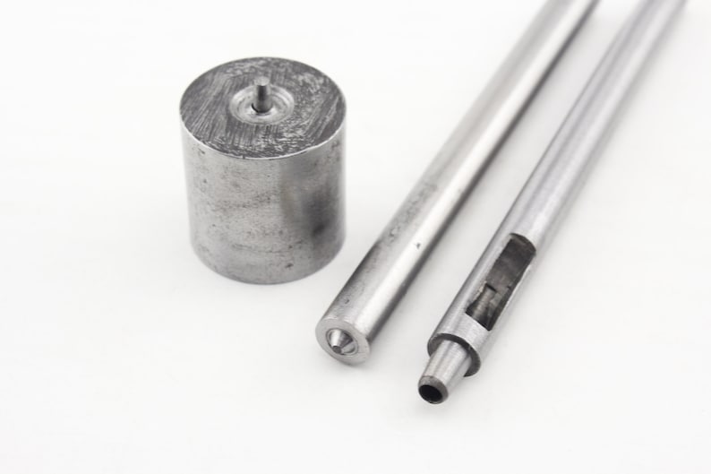 May include: A set of three metal tools for leather crafting. The tools include a round punch, a hollow punch, and a punch with a pointed tip.