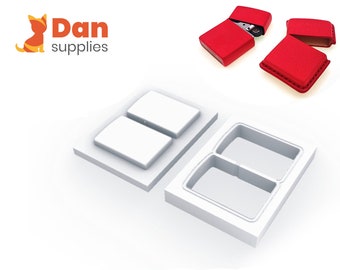 May include: Two white plastic moulds for making leather cases for lighters. The moulds are rectangular with two rectangular cutouts.