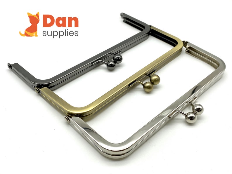 May include: Three purse frames in different finishes: silver, gold, and black. Each frame has two round metal clasps.