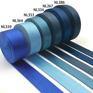 May include: A selection of blue webbing straps in various shades of blue, including navy, royal blue, and light blue. The straps are labeled with their product codes: NL339, NL364, NL353, NL334, NL267, and NL386.