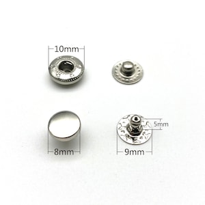May include: Two sets of silver metal snap fasteners. The larger set measures 10mm in diameter and the smaller set measures 9mm in diameter. The smaller set has a 5mm tall post.