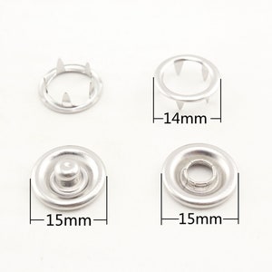 May include: Four silver metal snap fasteners, two with prongs and two with a dome-shaped top. The prongs are 14 mm in diameter and the dome-shaped tops are 15 mm in diameter.
