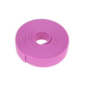 May include: A roll of purple, flat, flexible, rubber-like material. It is coiled into a circle.